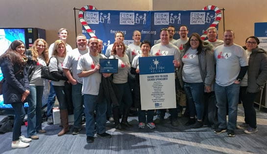 Group photo of employee volunteers at the Feed My Starving Children facility in Schaumburg, Illinois.