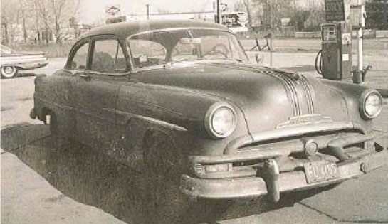 A sepia photo of Associated's first service vehicle, a '53 Pontiac with the rear seats removed to transport parts