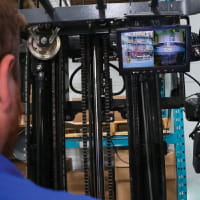 Integrated Vision System. A small monitor is placed at the top right of the inside of the forklift for the operator to view. The operator is able to see behind him and where the fork is.