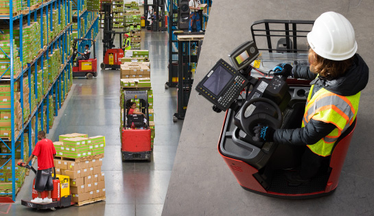 Two images. L: several forklifts in a warehouse aisle carrying loads. R: a stand-up forklift has a telematics device installed on it.