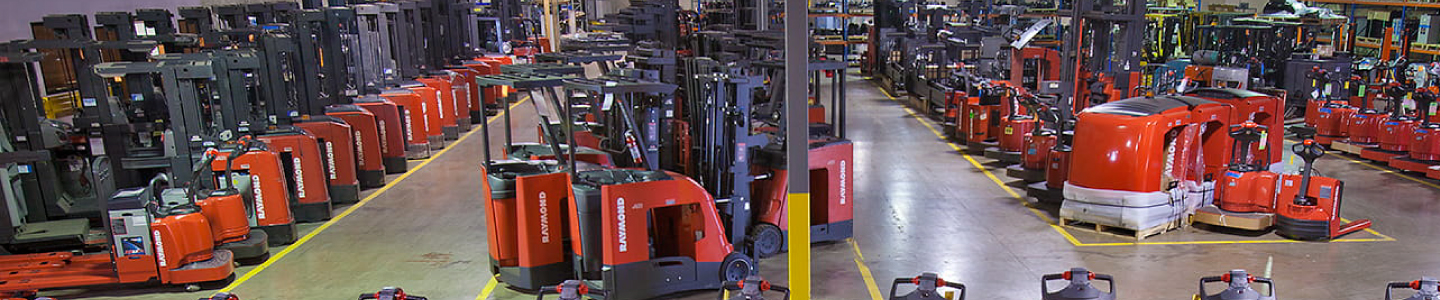 Warehouse space full of Raymond lift trucks