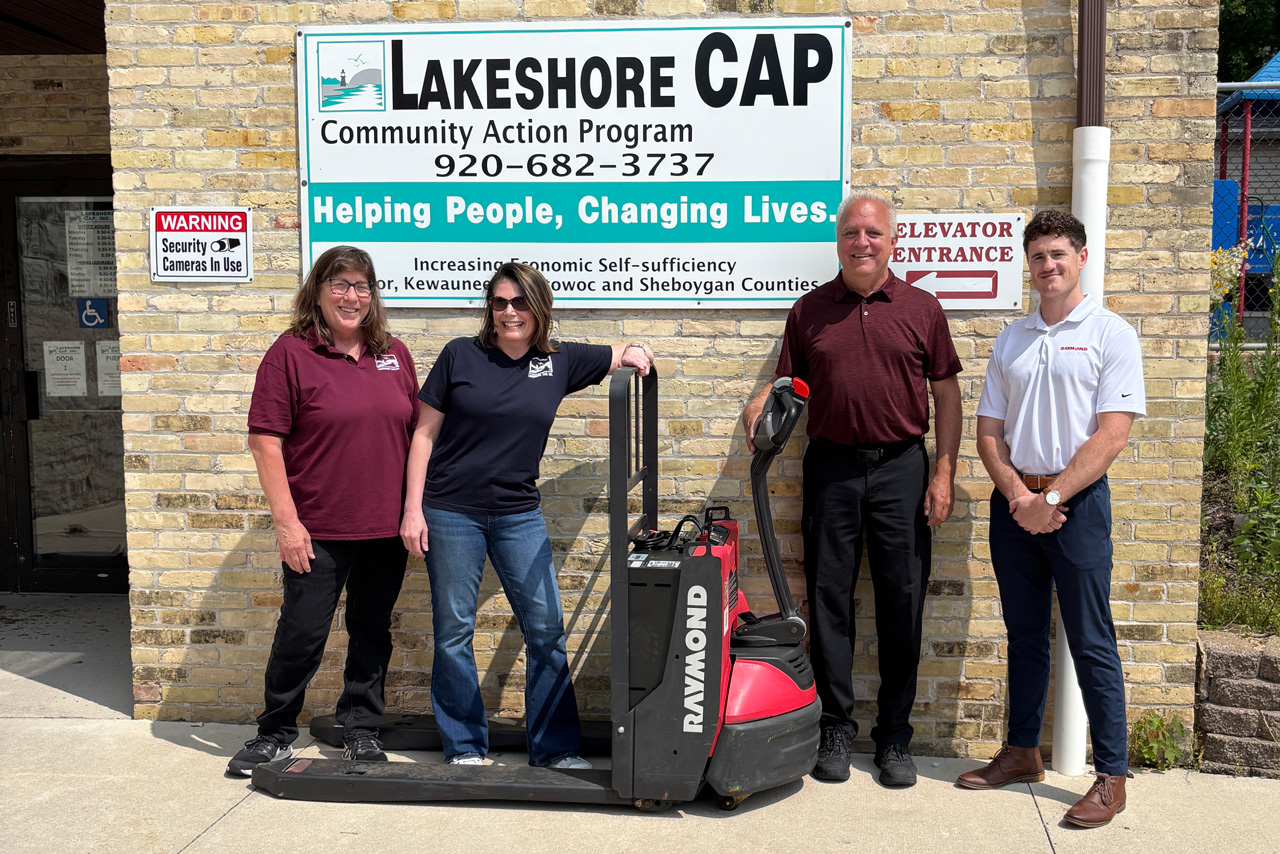 Associated and Lakeshore CAP employees in a group photo with the donated pallet truck